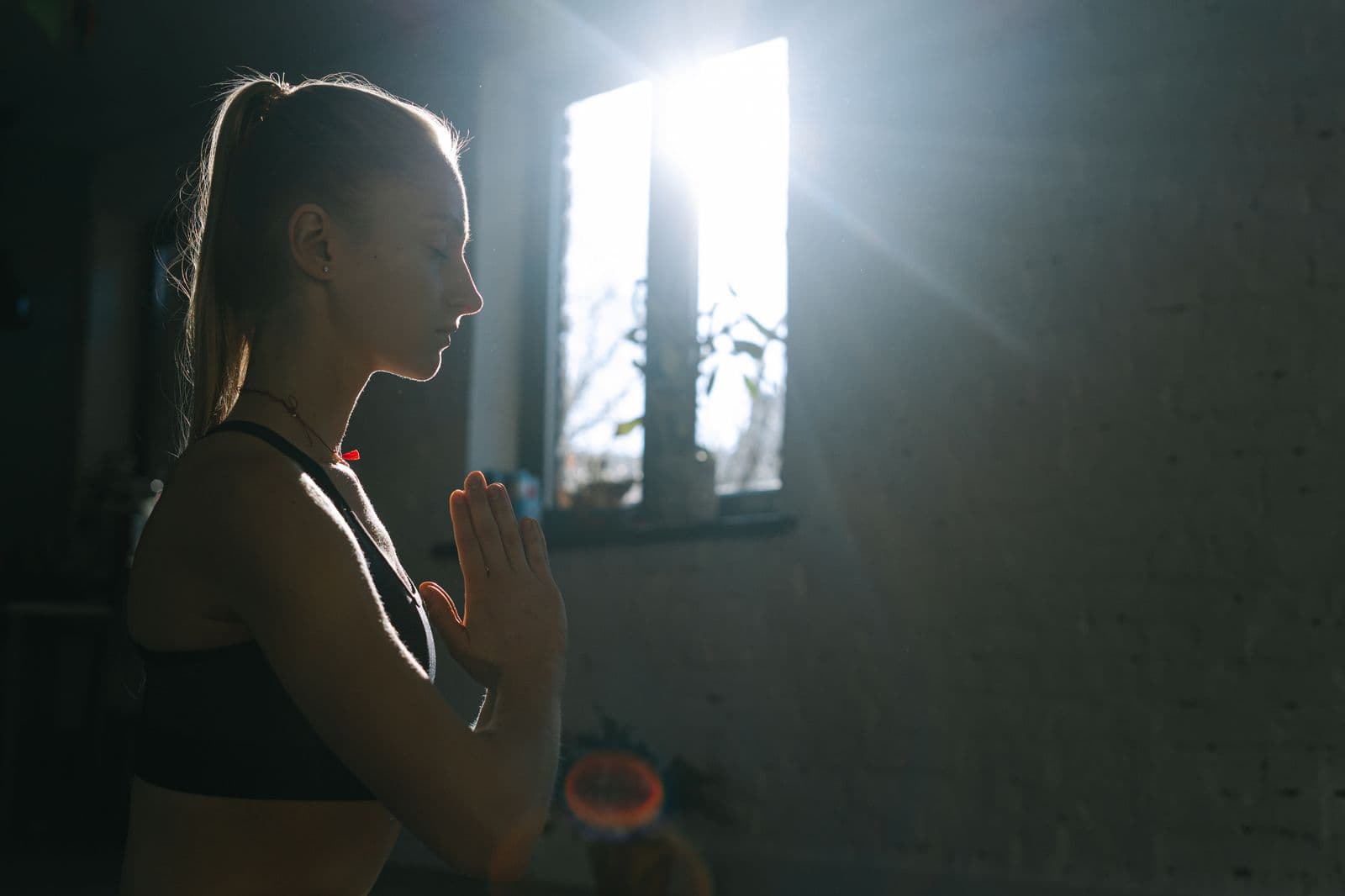Woman meditating by a window